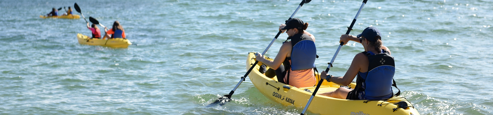  two girls kayaking across Biscayne Bay 