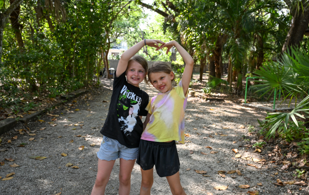 Two Girl Scouts holding hands at Camp Mahachee