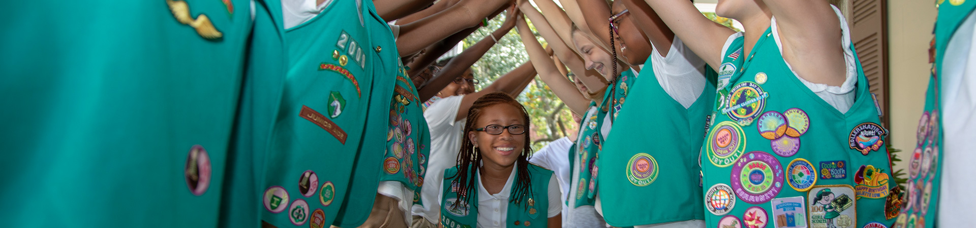  Girl Scouts going under a tunnel of arms 