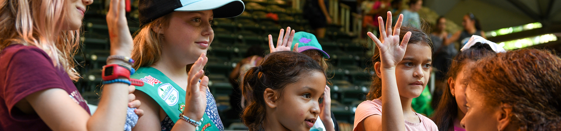  Girls smiling and raising hands 