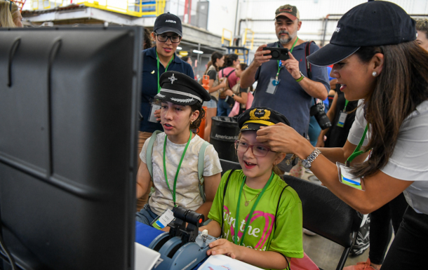 girl scouts having fun with flight simulator