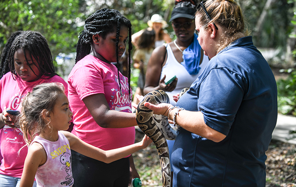 GIrl Scouts petting a snake
