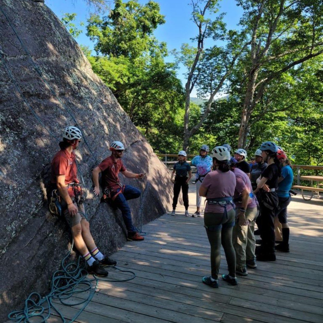 Older Girl Scout rock climbing