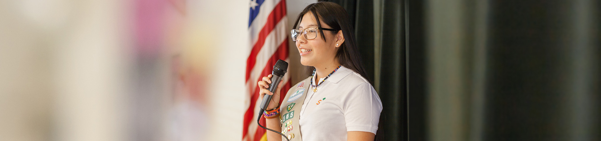  High school Girl Scout speaks into microphone 
