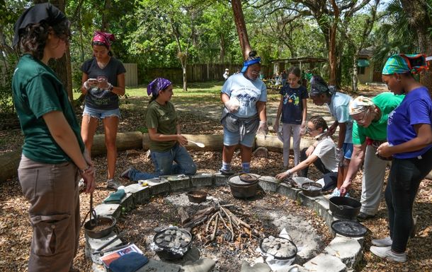 Girls building a campfire