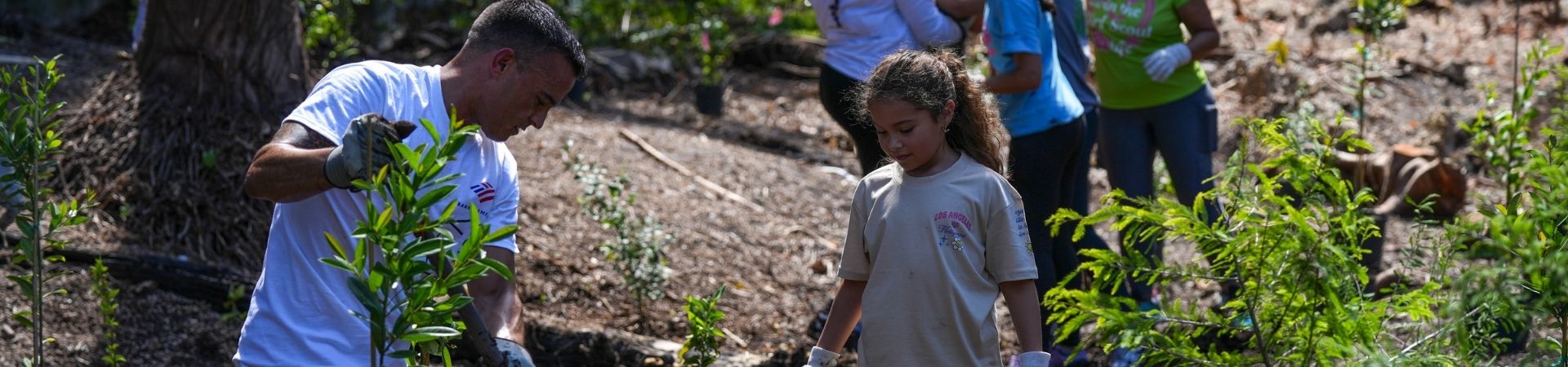  Happy Girl Scouts hiking with volunteer 